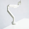 Thinking Works 2:22 Curve single monitor arm in matte white with a monitor fitted, front three-quarter view